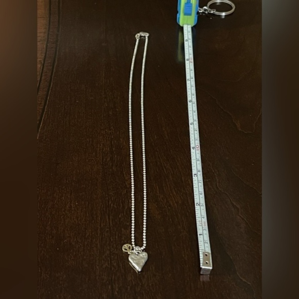 Silver Tone Hammered Heart and Gold Peace Necklace on 18” Chain.